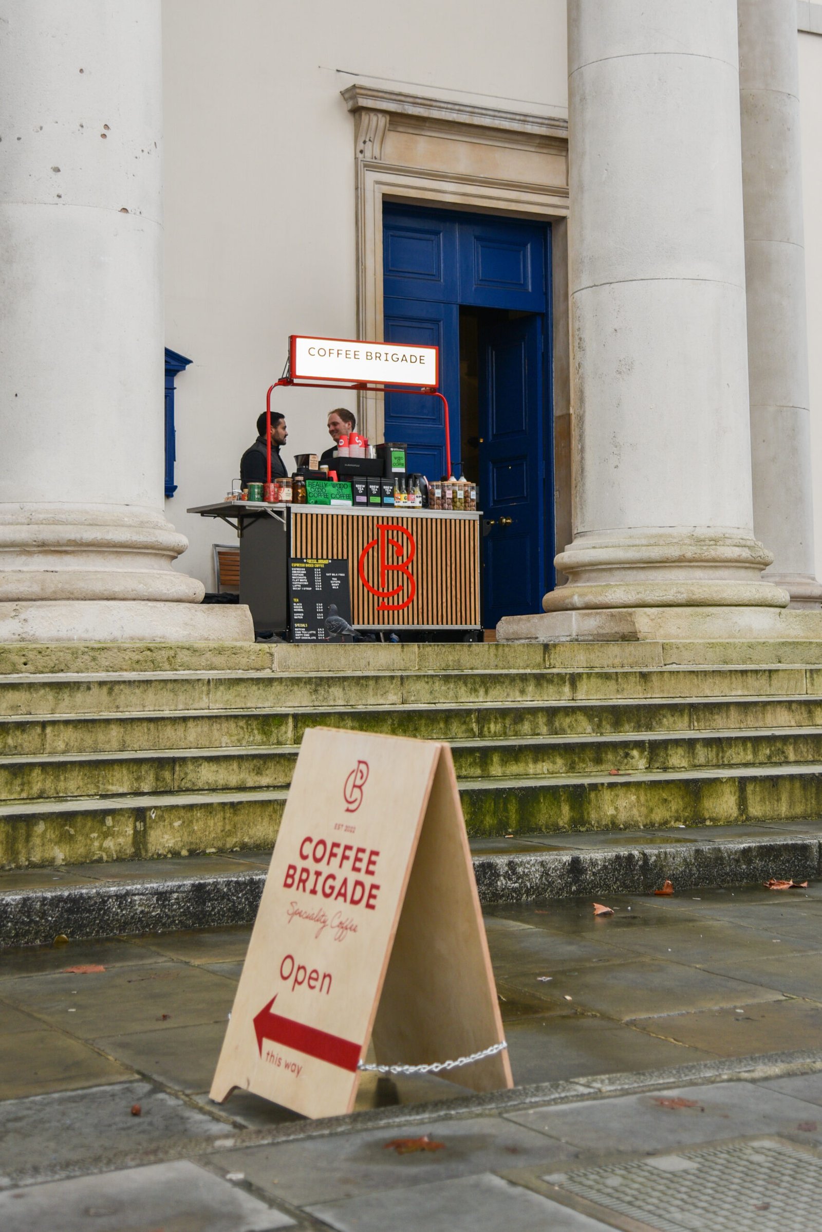 Baristas serving at the Coffee Brigade cart on the church steps
